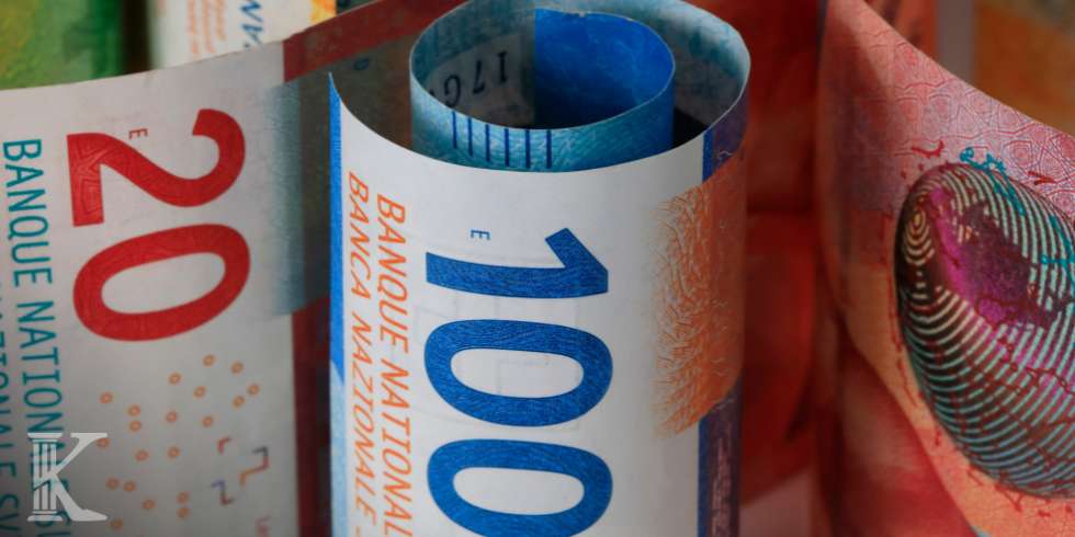 Rolled colorful banknotes, including a blue 1000 note, showing currency details and security features