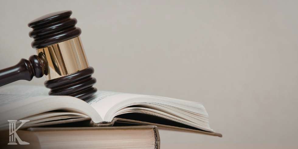 Gavel resting on open law book, symbolizing justice and legal proceedings