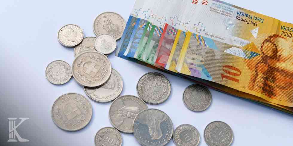 Euro banknotes scattered with coins on a light surface, suggesting money and cash exchange.